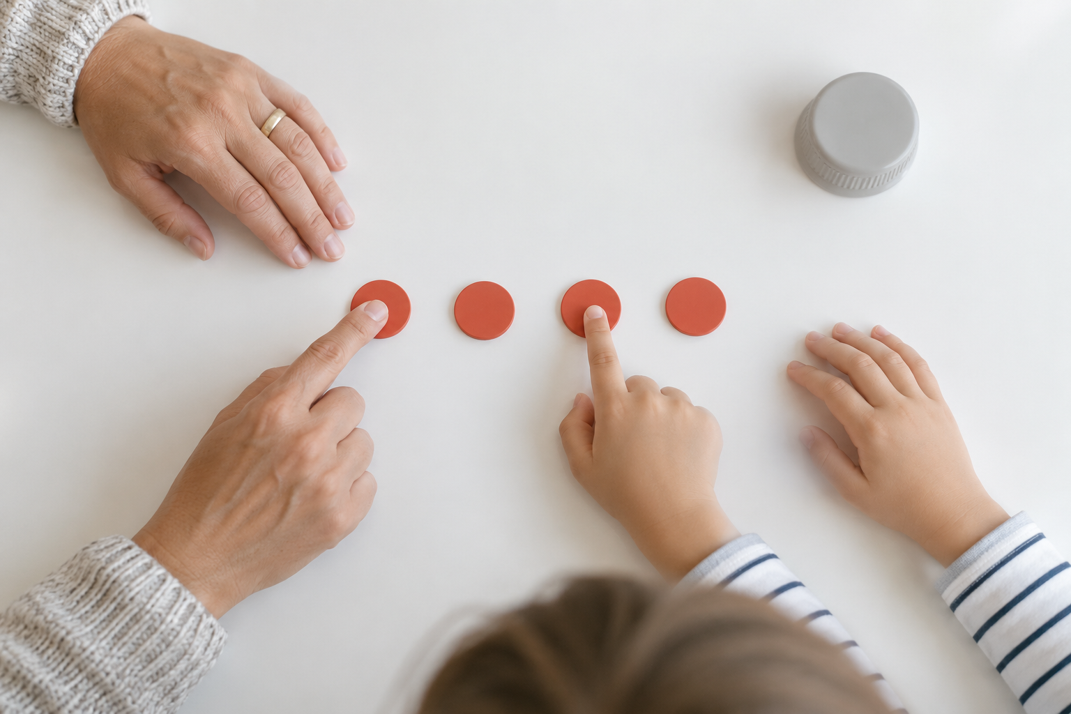 Representative adult and child hands tap four coral beat tokens in a steady row