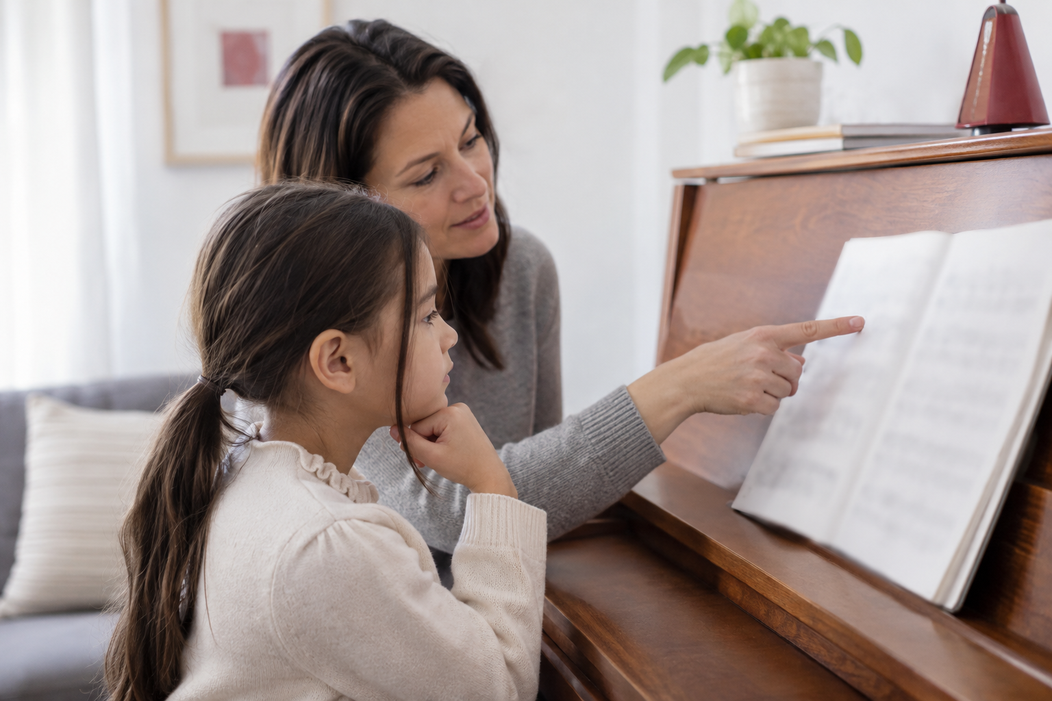 A parent and child identify the melody in beginner piano music