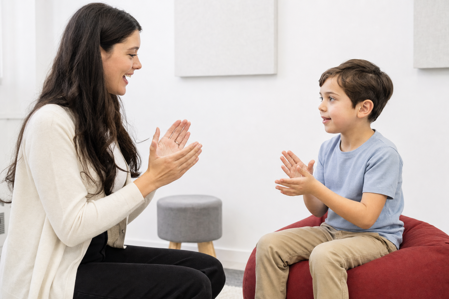 Teacher and child practicing a simple clap-and-count rhythm in a bright music room